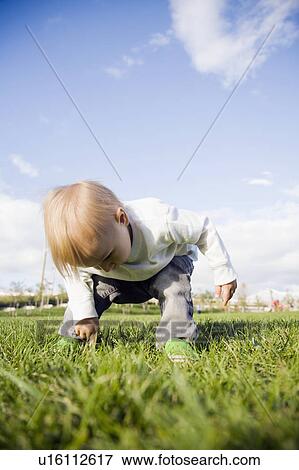 Stock Photo - Baby boy (0-1 years) on grass. Fotosearch