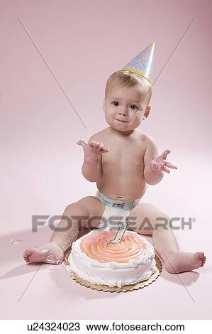 Baby girl (12-17 months) with first birthday cake View Large Photo Image Stock Image - Baby girl (12-17 months) with first birthday cake. Fotosearch