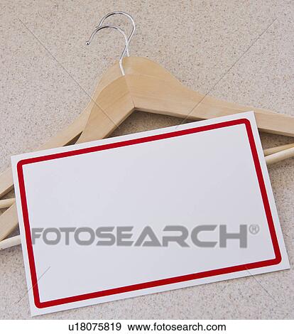 Stock Photo - Blank price tag and coat hangers. Fotosearch