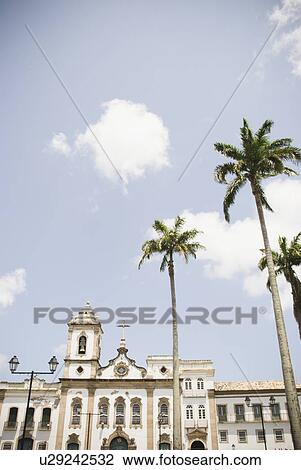 Stock Image - Brazil, Bahia, Salvador De Bahia, Facade of old church with palm trees in front. Fotosearch
