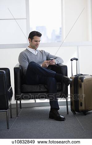 Businessman sitting in airport lounge View Large Photo Image Stock Photo - Businessman sitting in airport lounge. Fotosearch