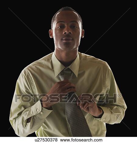 Businessman tying tie View Large Photo Image Stock Photo - Businessman tying tie. Fotosearch