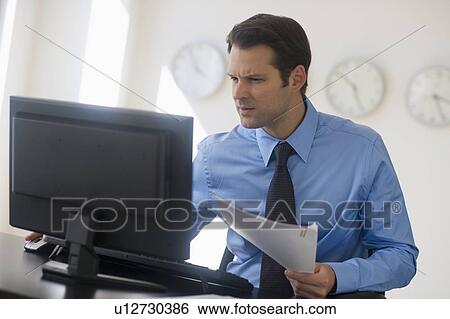 Stock Photograph - Businessman working on computer. Fotosearch