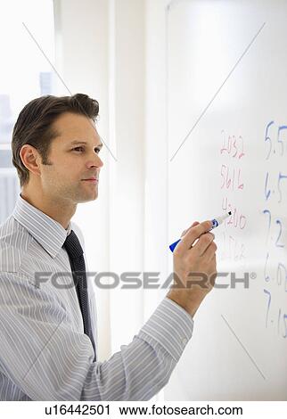 Businessman writing on whiteboard View Large Photo Image Stock Image - Businessman writing on whiteboard. Fotosearch