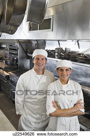 Stock Photograph - Chef and cook in commercial kitchen. Fotosearch