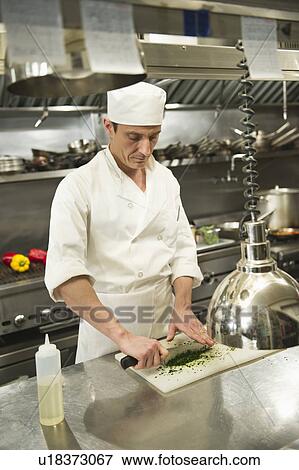 Chef preparing food in kitchen View Large Photo Image Stock Photo - Chef preparing food in kitchen. Fotosearch