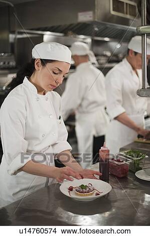 Picture - Chefs preparing food in kitchen. Fotosearch