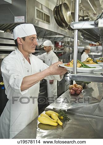 Chefs preparing food in kitchen View Large Photo Image Picture - Chefs preparing food in kitchen. Fotosearch
