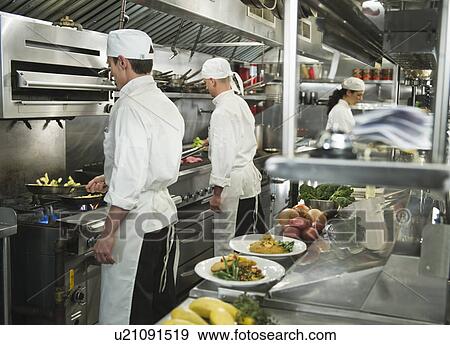 Chefs preparing food in kitchen View Large Photo Image Stock Photo - Chefs preparing food in kitchen. Fotosearch