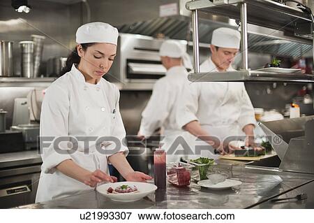 Stock Photo - Chefs preparing food in kitchen. Fotosearch
