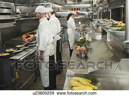 Chefs preparing food in kitchen View Large Photo Image Stock Photo - Chefs preparing food in kitchen. Fotosearch