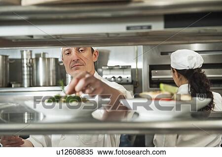 Chefs preparing food in kitchen View Large Photo Image Stock Photography - Chefs preparing food in kitchen. Fotosearch