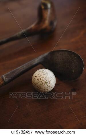 Stock Photo - Close up of antique golf clubs and golf ball. Fotosearch