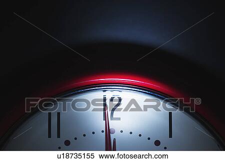 Stock Photography - Close up of clock face showing midnight. Fotosearch