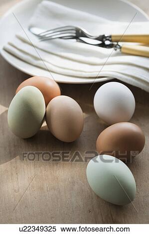 Stock Photography - Close up of eggs and plate on table. Fotosearch
