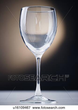 Stock Photo - Close up of empty wine glass on black background. Fotosearch