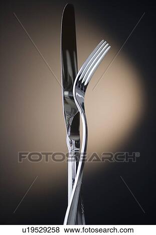 Stock Photo - Close up of fork and knife on black background. Fotosearch