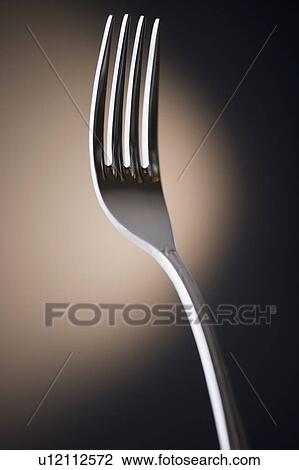 Stock Image - Close up of fork on black background. Fotosearch