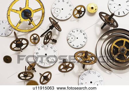 Stock Image - Close up of gears and clock parts on white background. Fotosearch