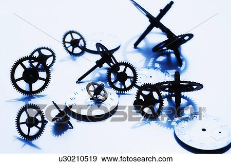 Stock Photo - Close up of gears and clock parts on white background. Fotosearch