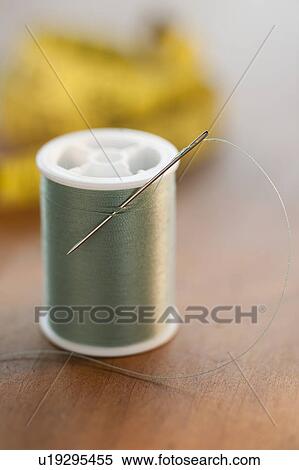 Close-up of green thread spool with needle View Large Photo Image Stock Photography - Close-up of green thread spool with needle. Fotosearch