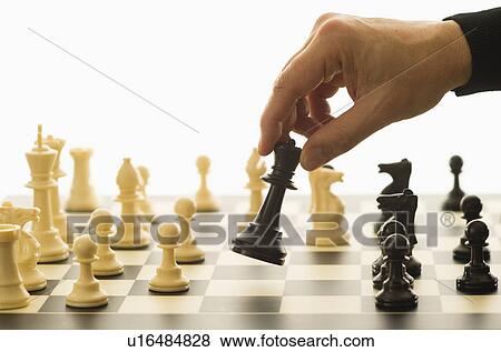 Close-up of man's hand playing chess View Large Photo Image Stock Photo - Close-up of man's hand playing chess. Fotosearch