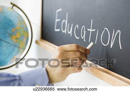 Close-up of man's hand writing "education" on blackboard View Large Photo Image Stock Photography - Close-up of man's hand writing "education" on blackboard. Fotosearch