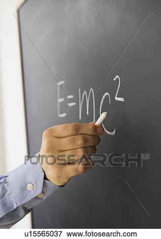 Close-up of man's hand writing theory of relativity formula on blackboard View Large Photo Image Stock Photo - Close-up of man's hand writing theory of relativity formula on blackboard. Fotosearch