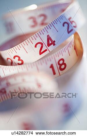 Picture - Close-up of measure tape, studio shot. Fotosearch