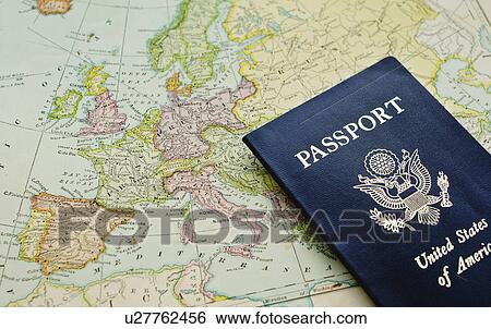 Stock Photograph - Close-up of passport lying on European map. Fotosearch