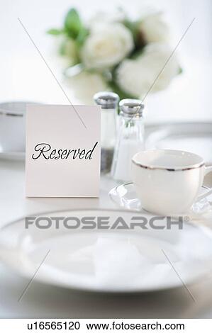Close up of place setting with reserved sign View Large Photo Image Stock Image - Close up of place setting with reserved sign. Fotosearch