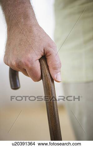 Close-up of senior man's hand on cane View Large Photo Image Picture - Close-up of senior man's hand on cane. Fotosearch