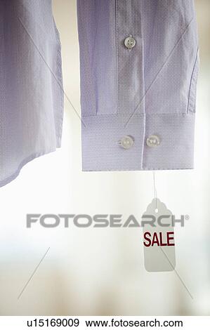 Close up of shirt cuff with sale tag View Large Photo Image Stock Photo - Close up of shirt cuff with sale tag. Fotosearch