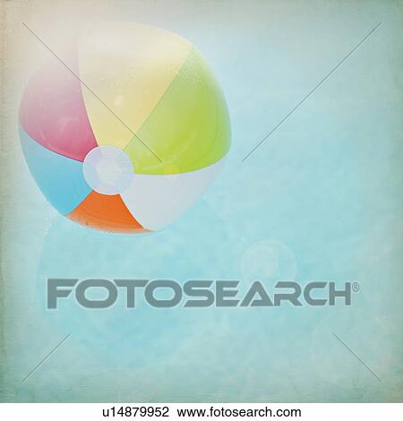 Stock Image - Close up of striped beach ball against water surface. Fotosearch