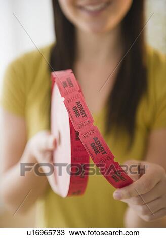 Close up of woman holding tape with "admit one" tickets in roll View Large Photo Image Stock Image - Close up of woman holding tape with "admit one" tickets in roll. Fotosearch
