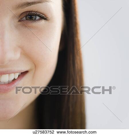 Stock Image - Close up of young woman's face. Fotosearch