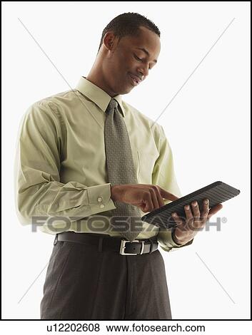 Stock Photo - Content young businessman examining file. Fotosearch
