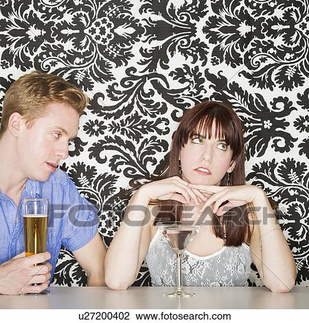 Stock Image - Couple at bar counter. Fotosearch