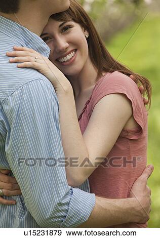 Stock Photo - Couple embracing outdoors. Fotosearch