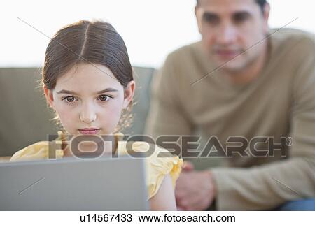 Daughter (8-9) and father using laptop View Large Photo Image Stock Image - Daughter (8-9) and father using laptop . Fotosearch