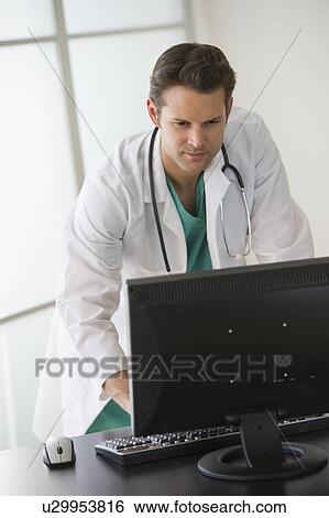 Doctor working on computer View Large Photo Image Stock Photograph - Doctor working on computer. Fotosearch