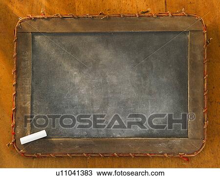 Stock Image - Empty chalkboard with chalk, studio shot. Fotosearch