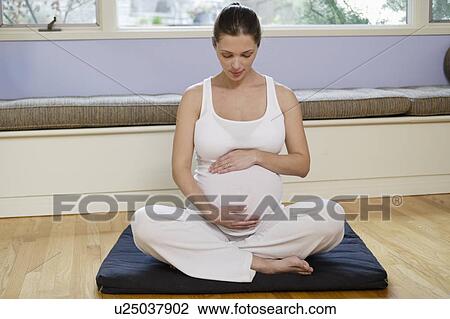 Stock Image - Expectant mother exercising. Fotosearch