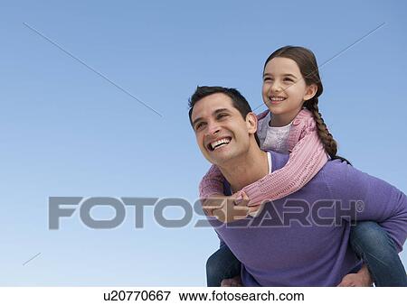 Father giving piggyback ride to daughter (8-9) View Large Photo Image Stock Photo - Father giving piggyback ride to daughter (8-9). Fotosearch