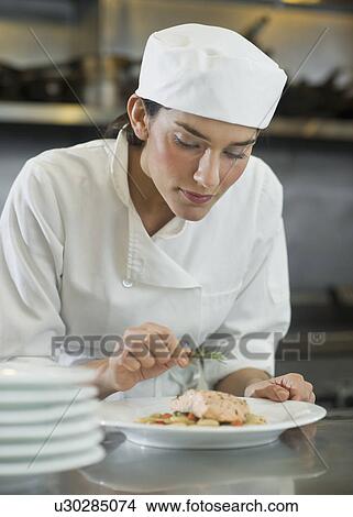 Female cook preparing food in commercial kitchen View Large Photo Image Picture - Female cook preparing food in commercial kitchen. Fotosearch