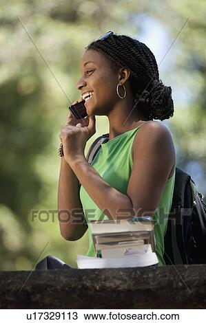 Female student using mobile phone View Large Photo Image Stock Image - Female student using mobile phone. Fotosearch