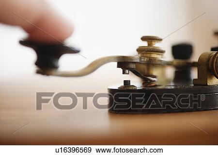 Stock Photo - Finger pressing telegraph key, studio shot. Fotosearch