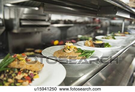 Stock Image - Food on plates in the kitchen. Fotosearch