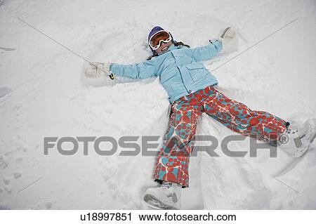 Girl (10-11) in ski gear doing snow angel View Large Photo Image Stock Image - Girl (10-11) in ski gear doing snow angel. Fotosearch