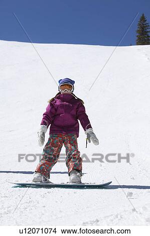Picture - Girl (10-11) snowboarding . Fotosearch